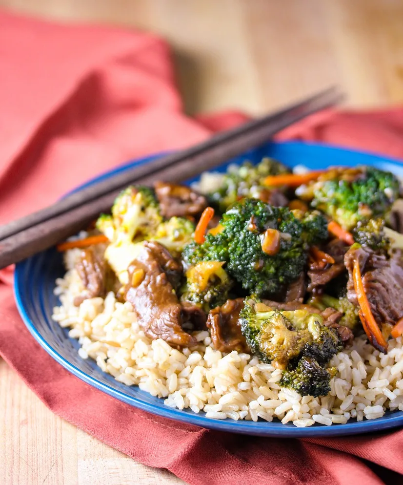 Side shot of finished and plated Beef and Broccoli Stir Fry served over rice