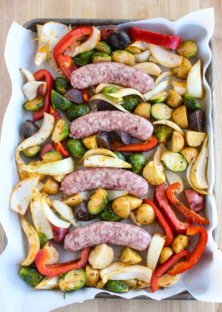 Showing the Bratwurst and Roasted Vegetables on the sheet pan before roasting
