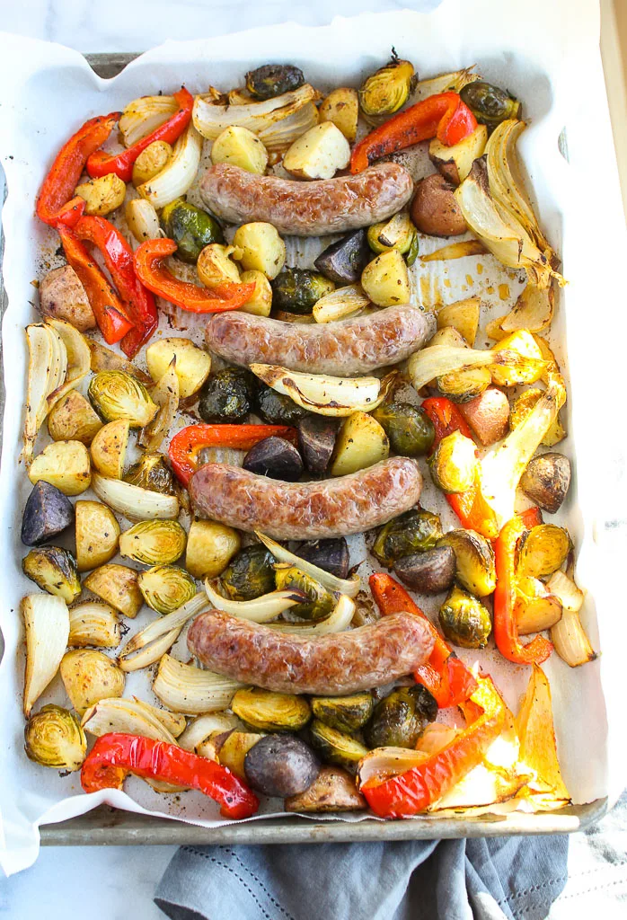 Overhead photo of the Sheet Pan Bratwurst and Roasted Vegetables on the sheet pan after roasting.