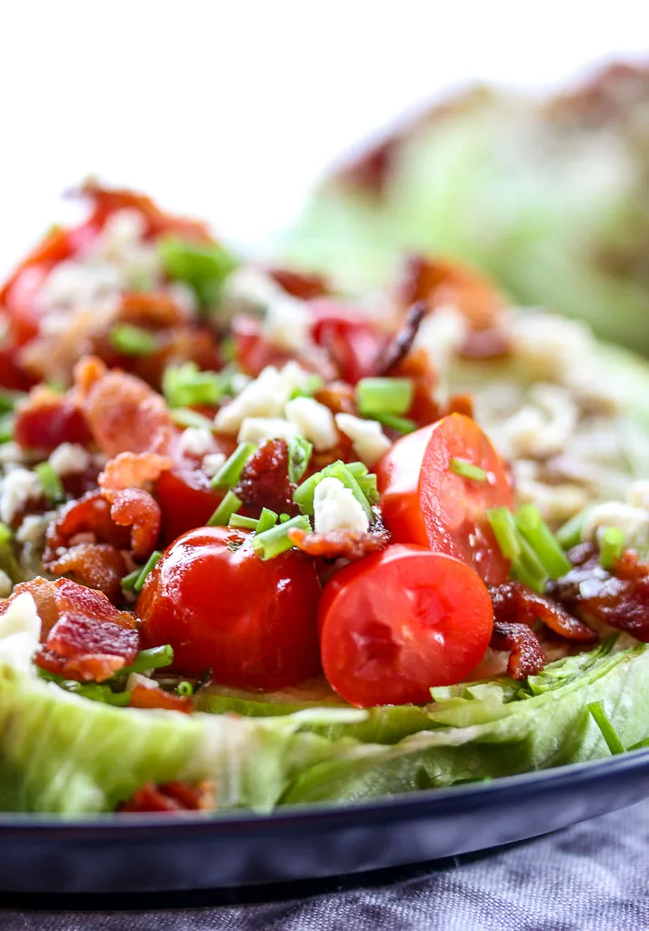 Close up of wedge salad highlighting the tomatoes