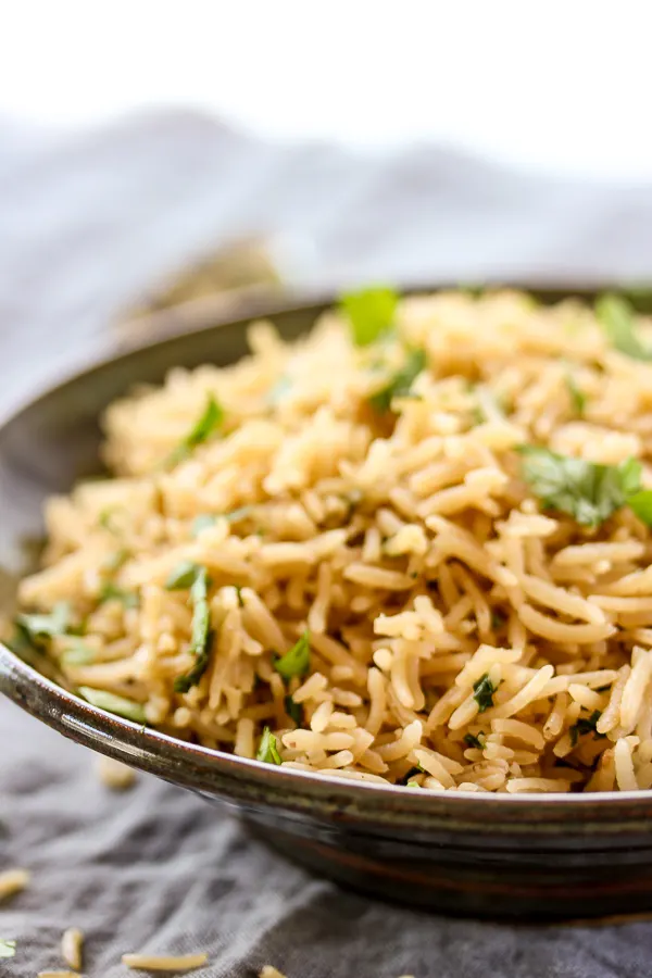 This Asian rice pilaf brings rice to a new level with it's wonderfully savory flavor and tastes amazing paired with grilled meats or fish. | lisasdinnertimedish.com