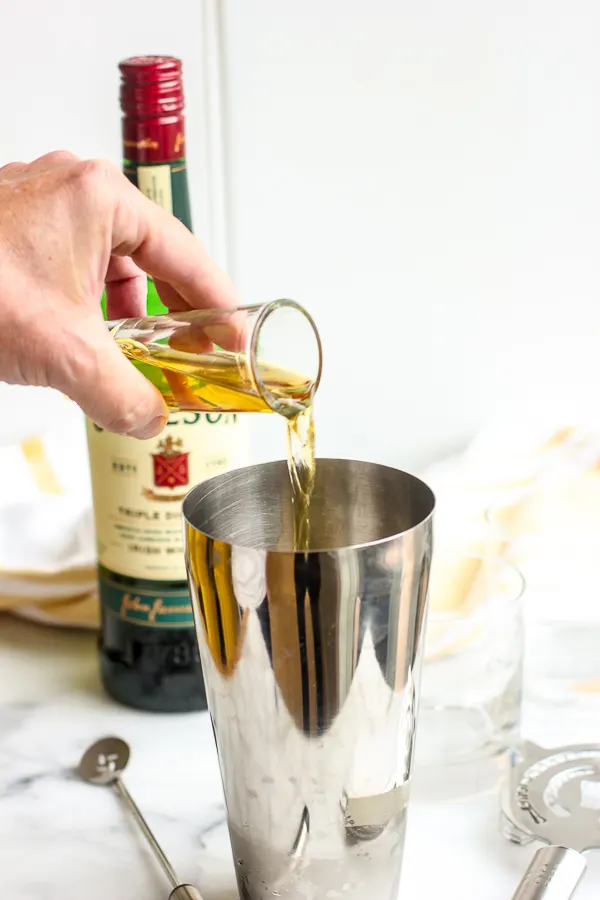 Pouring the Jameson into a cocktail shaker