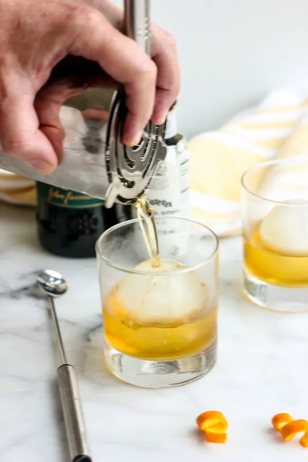 Pouring the jameson old fashioned into a cocktail glass