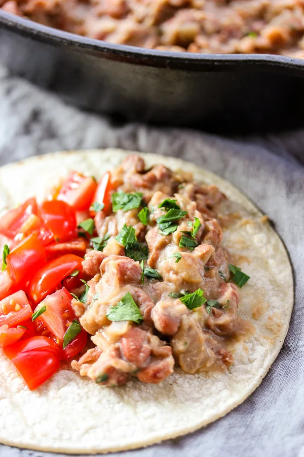 These Homemade Refried Beans are so flavorful and they couldn't be easier to make. I promise, once you make them you will never want to go back to canned again. 