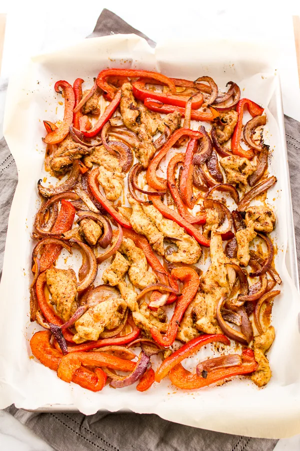 roasted chicken, peppers and onions on a sheet pan