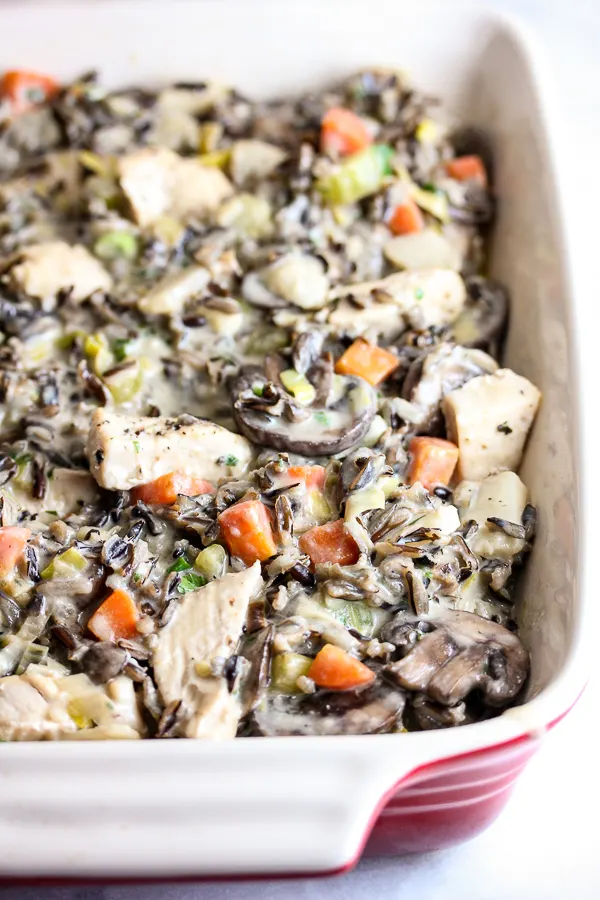 Close up of the chicken wild rice casserole in the baking dish before baking.