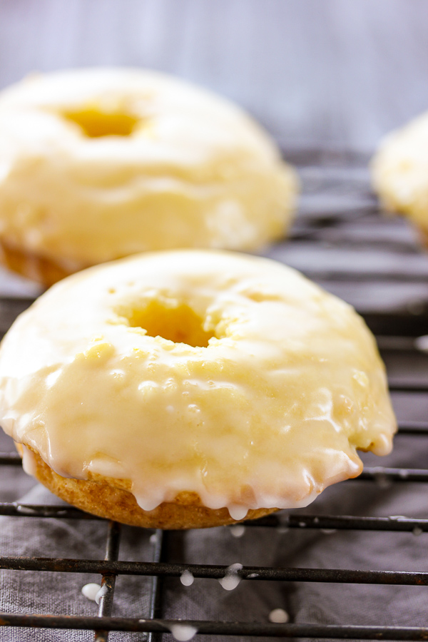 These baked glazed lemon donuts couldn't be easier to make and are bursting with fresh, tangy lemon flavor. They are guaranteed to disappear quickly.