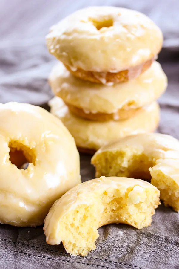 These baked glazed lemon donuts couldn't be easier to make and are bursting with fresh, tangy lemon flavor. They are guaranteed to disappear quickly.