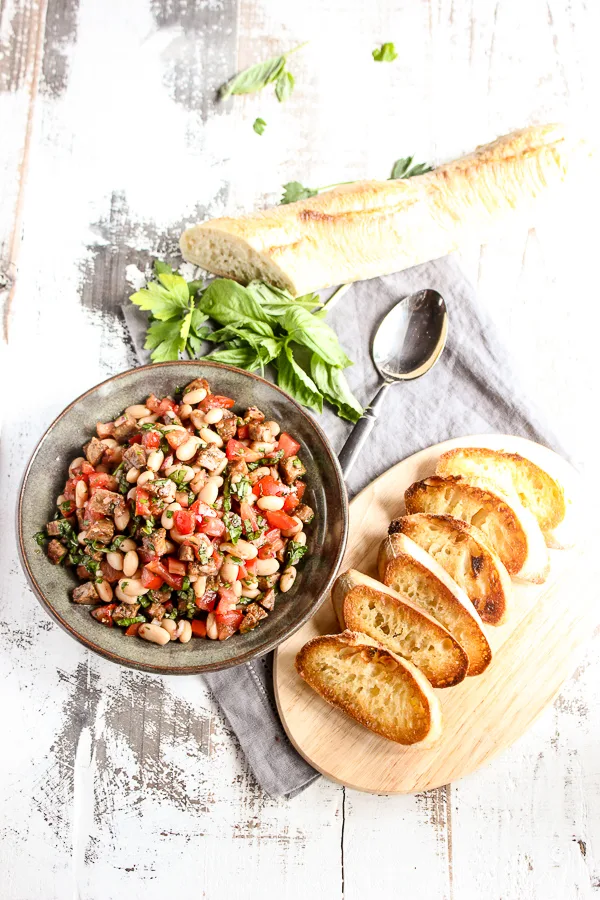 Overhead photo of finished bruschetta served with toasted baguette