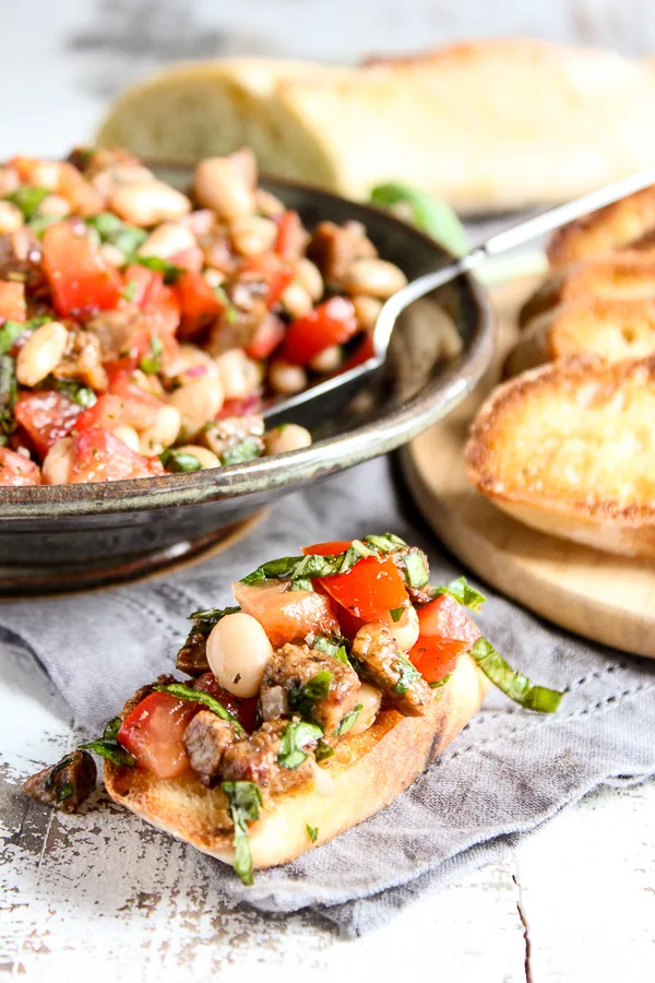 Close up of bruschetta on a piece of toasted baguette