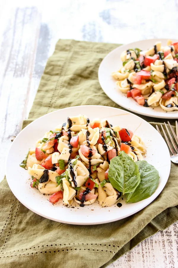 This Tortellini Caprese Salad is sure to become your favorite summer salad.  It takes less than 30 minutes to prepare and tastes absolutely amazing.