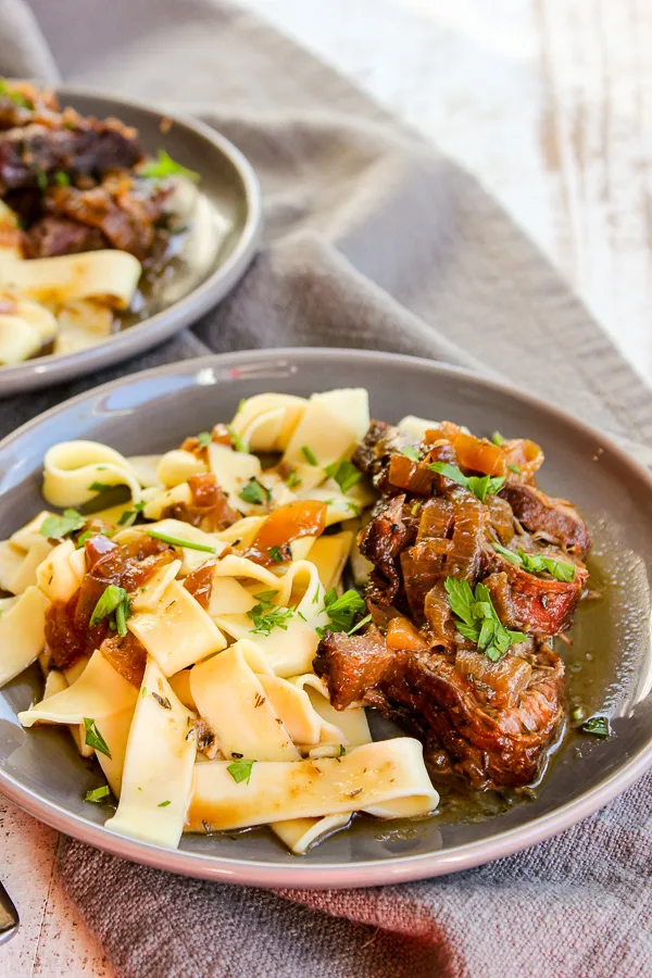 Beer Braised Pot Roast served with the sauce and egg noodles
