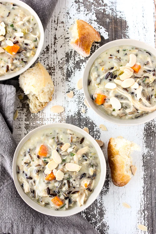 Overhead photo of Instant Pot Chicken Wild Rice Soup served in bowls with crusty bread