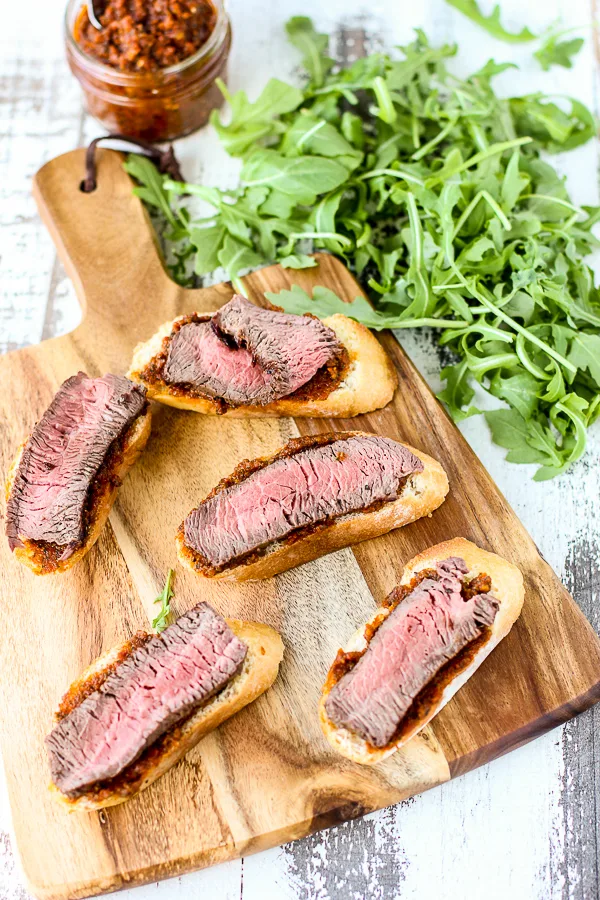 Sun-Dried Tomato Pesto Beef Crostini before being topped with arugula