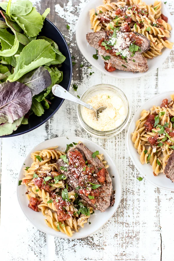 Overhead Instant Pot Tomato Red Wine Braised Pot Roast plated with pasta and tomato sauce