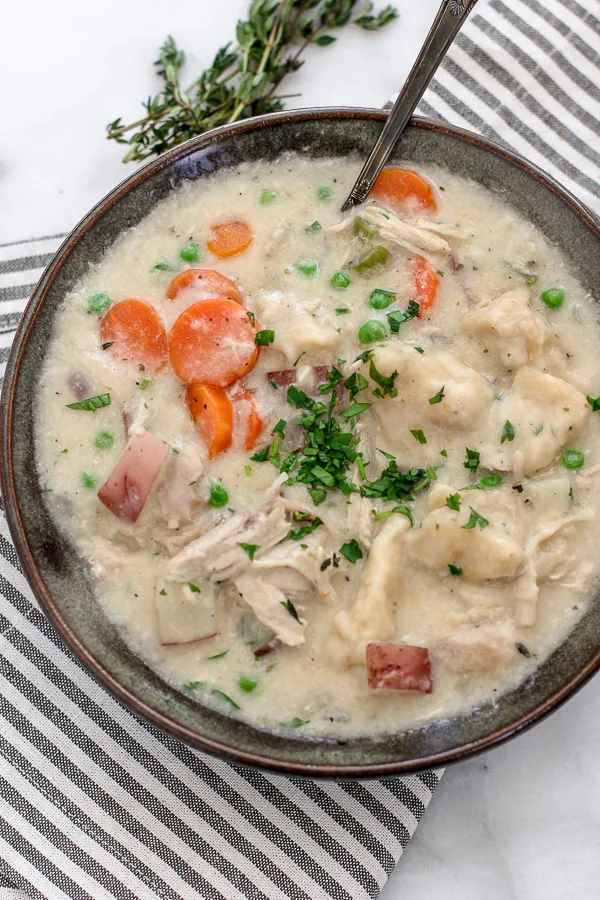 Close up of Weeknight Chicken and Dumplings being served in a bowl.