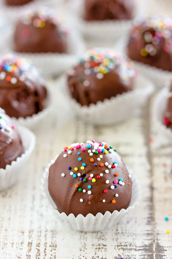 Peanut Butter Chocolate Dipped Cookie Dough Truffles topped with sprinkles