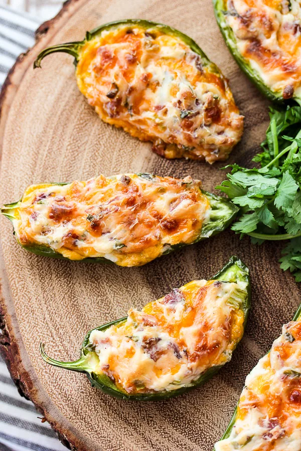 Close up overhead shot of Bacon Cheese Jalapeno Poppers on a serving board