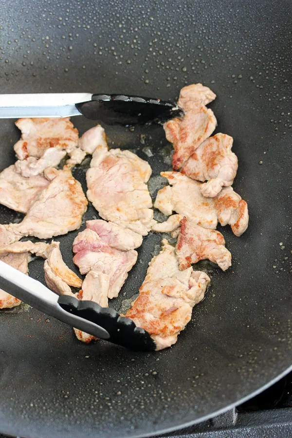 Stir frying the pork tenderloin strips