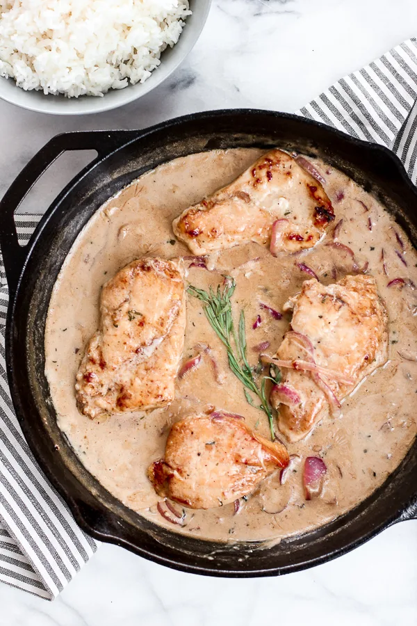 Overhead of finished Skillet Chicken with Creamy Mustard Sauce in the cast iron skillet.