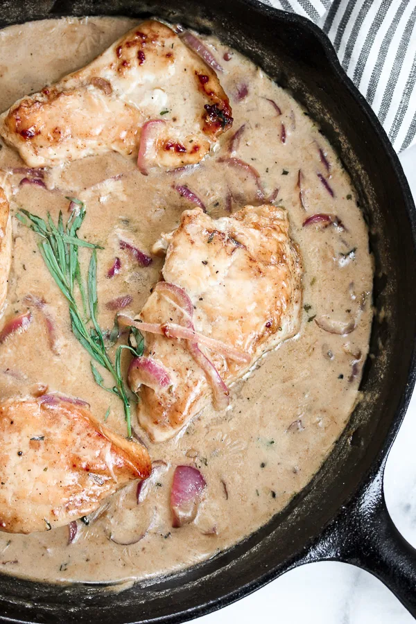 Overhead photo of finished Skillet Chicken with Creamy Mustard Sauce in a cast iron pan