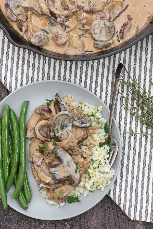 Plate of skillet beef stroganoff over rice with green beans