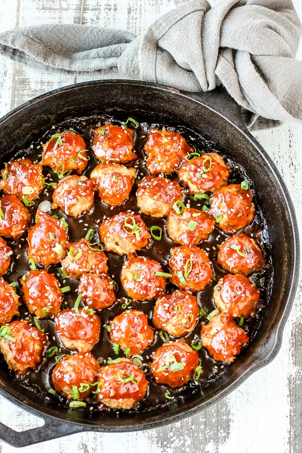 Finished meatball displayed in a cast iron skillet