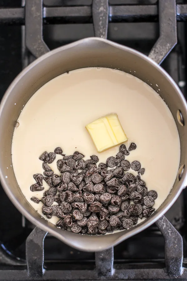 Chocolate chips, butter and evaporated milk in a sauce pan before melting