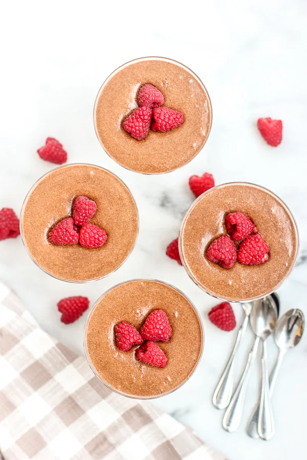 Totally Decadent Chocolate Mousse ready to be served and garnished with raspberries