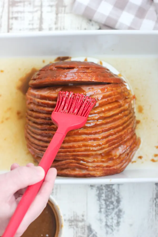Demonstrating how to brush the glaze on the ham
