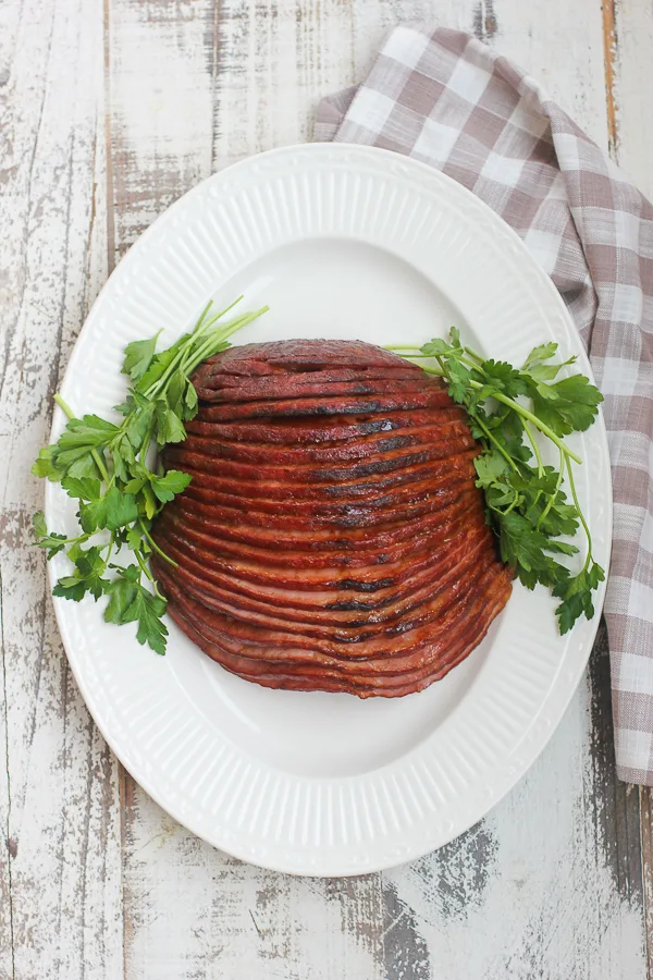 Baked ham with apricot mustard glaze plated and ready to serve