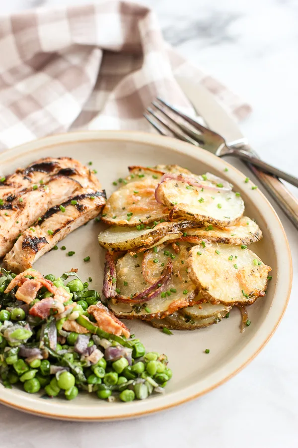 parmesan roasted potatoes served with chicken and peas