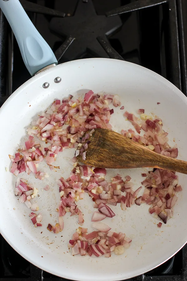 chopped red onion sautéing in a skillet