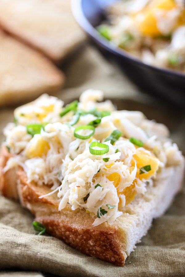 Closeup of piece of sourdough with crab salad on top