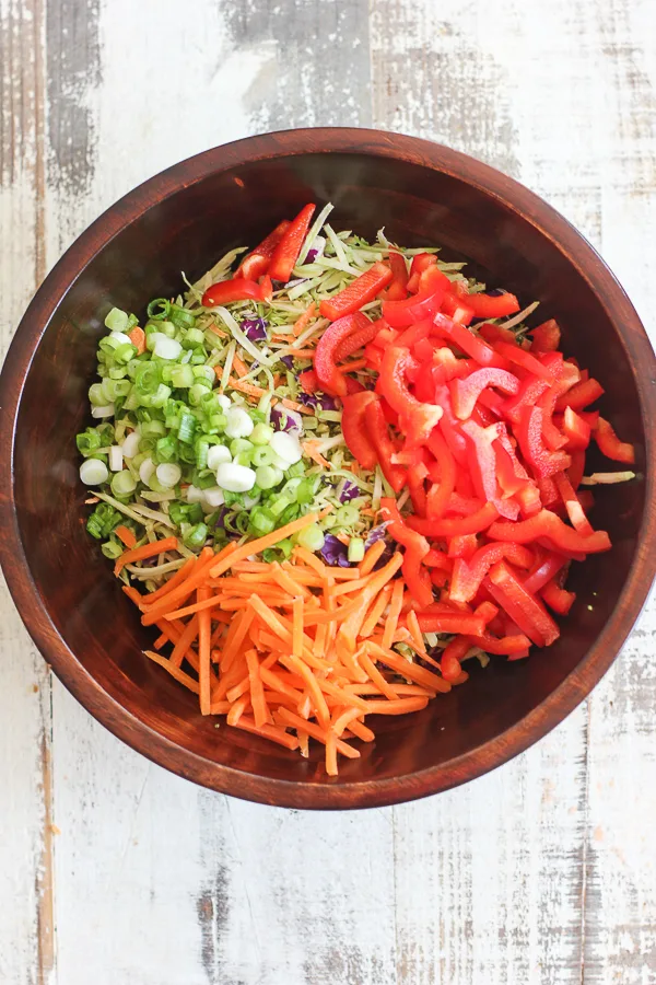 Prepped vegetables in the salad bowl before tossing with the dressing and sunflower seeds