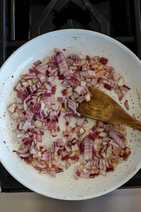 Sautéing chopped onion in the skillet