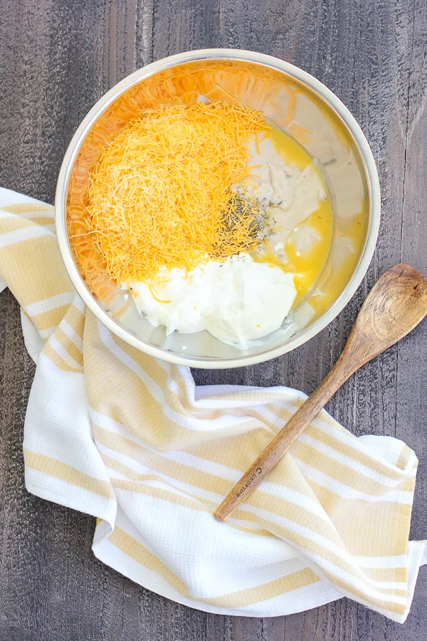 Cheese, sour cream and cream soups in a mixing bowl before combining.