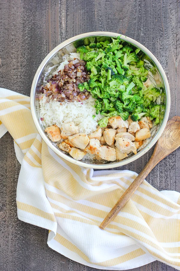 Broccoli, sautéed onion, rice and sautéed chicken add to the mixing bowl before combining with the cheese mixture