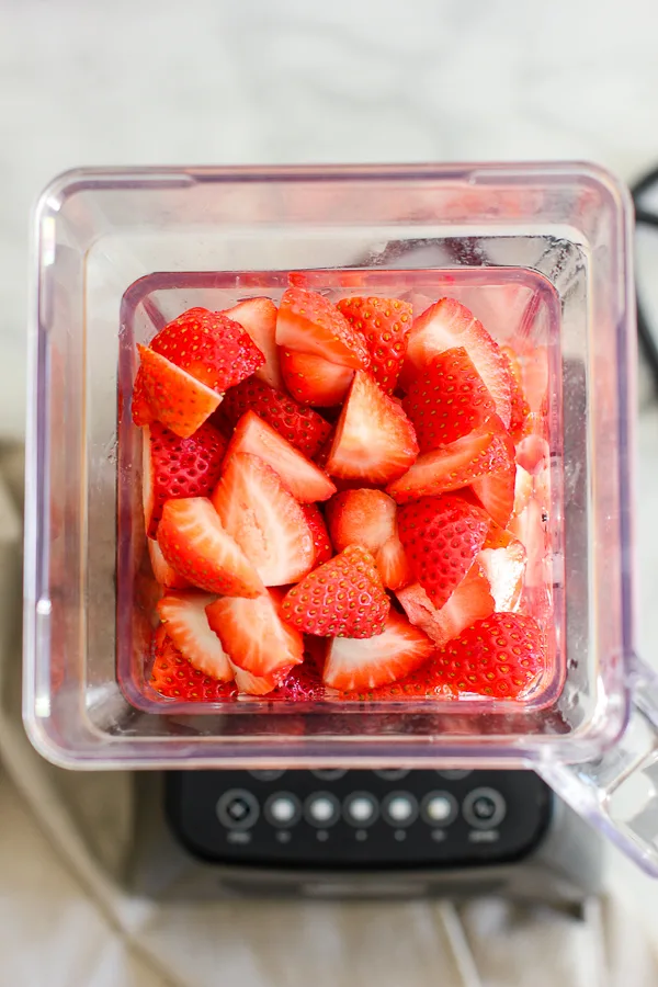 Quartered strawberries in blender before pureeing