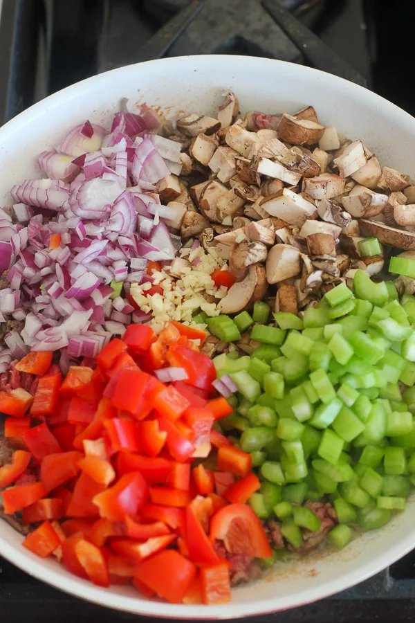 The chopped vegetable in the skillet before sautéing