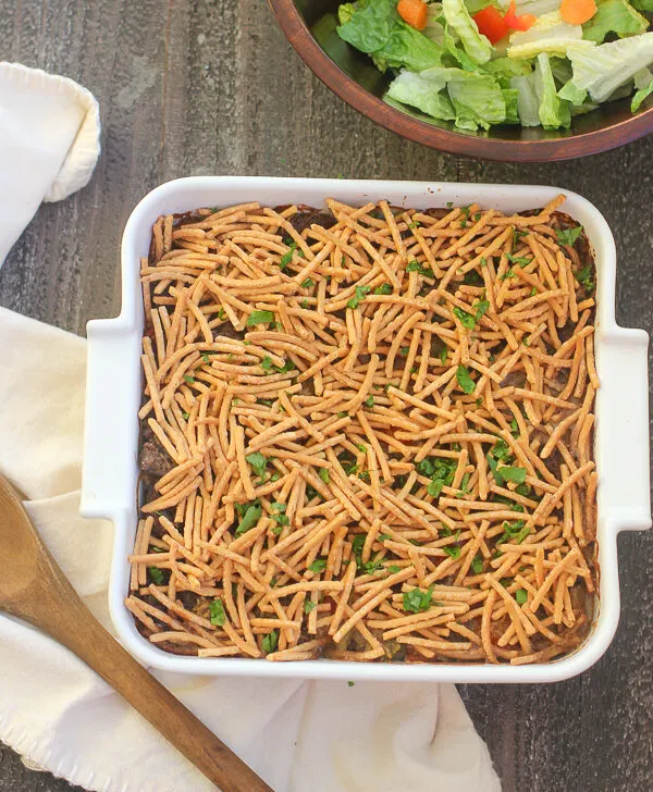 Overhead photo of the casserole in the baking dish after baking with a side salad