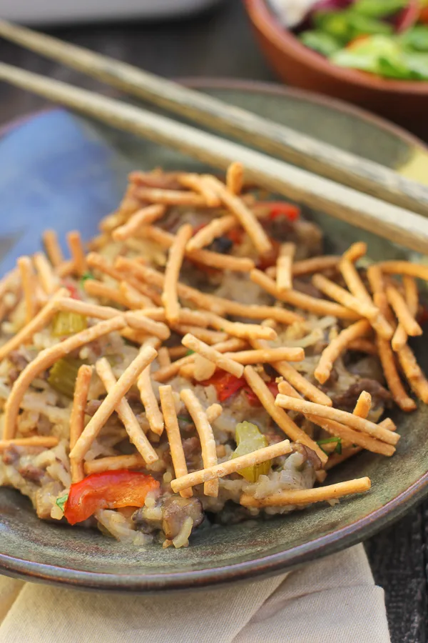 Close up photo of chow mien casserole served in a bowl with chop sticks