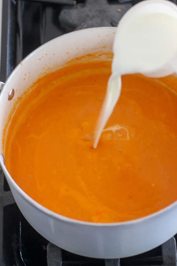 Pouring the half and half into the soup