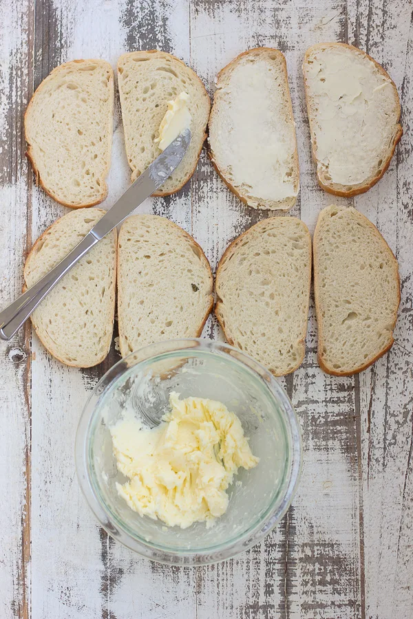 Spreading the garlic butter on the sourdough bread slices